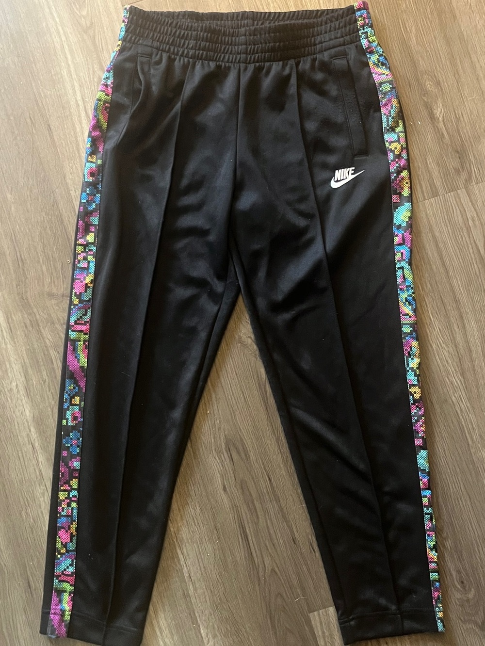 Nike sports wear black track pants   Thick multi coloured stripe down the sides